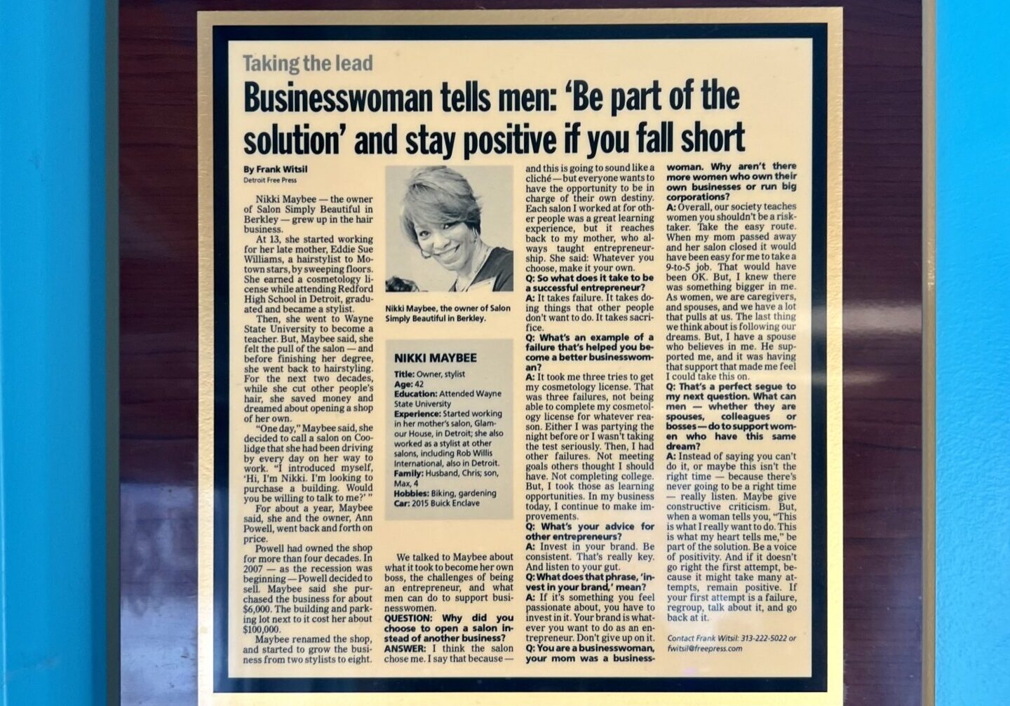 A newspaper article on the wall of a room.